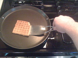 Kitchen turner slides under food