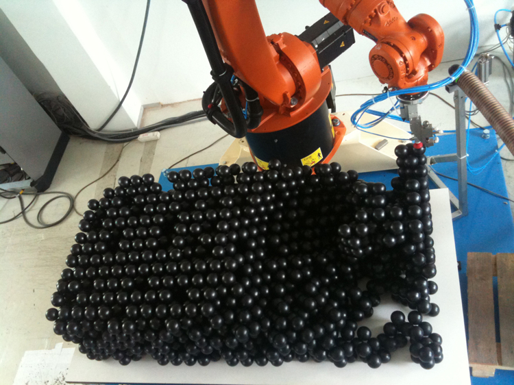 Robot assemble black ping pong balls