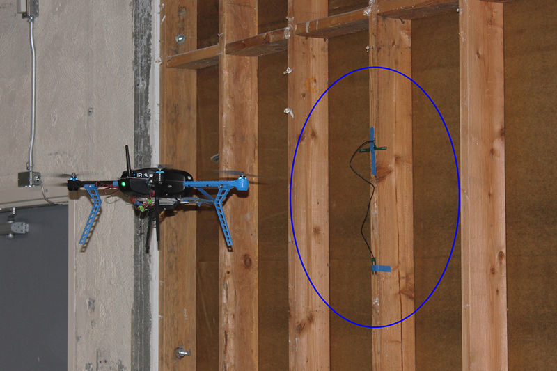 Drone reading sensor tag in tree